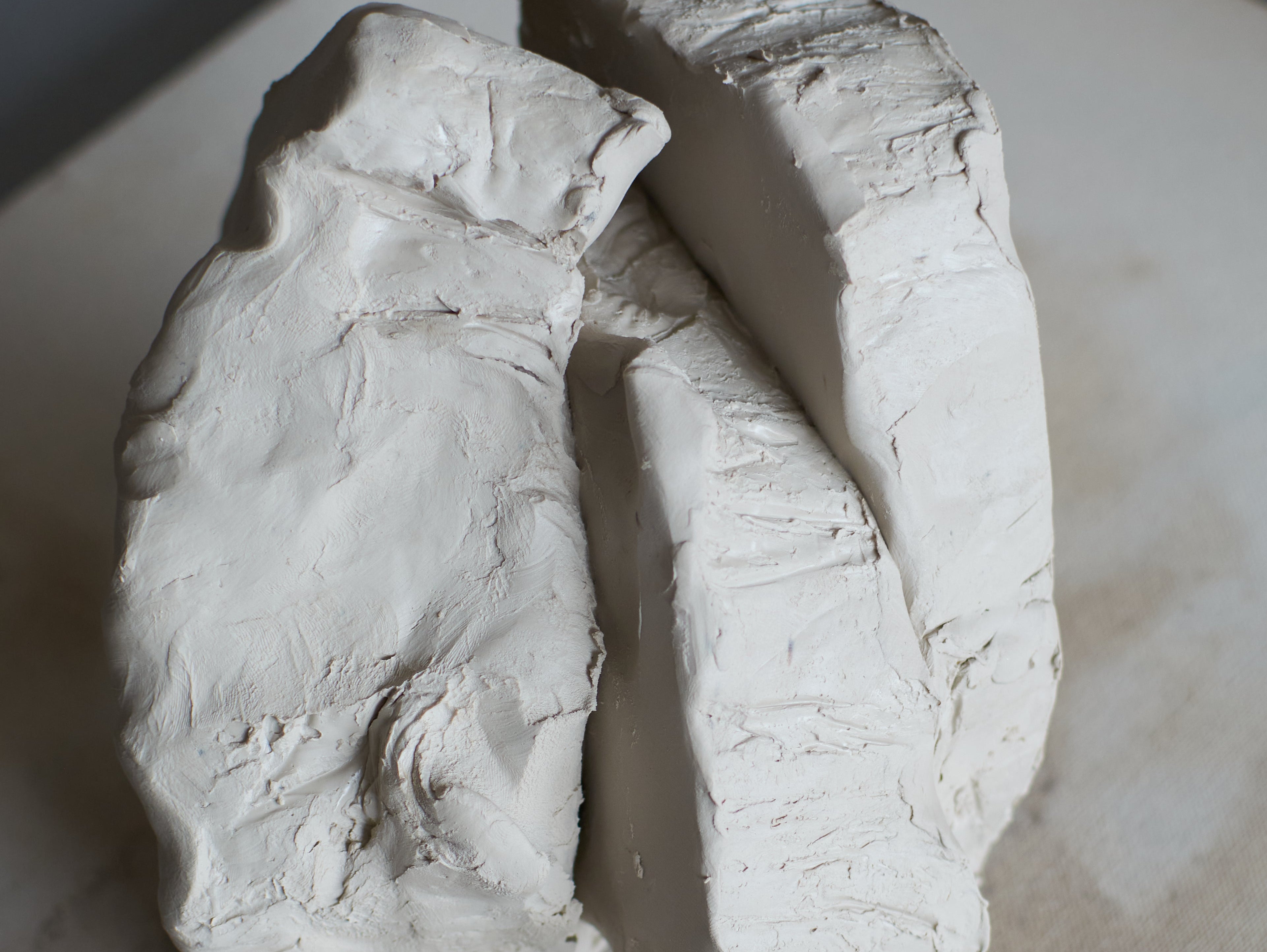Porcelain clay body on a kneading table.