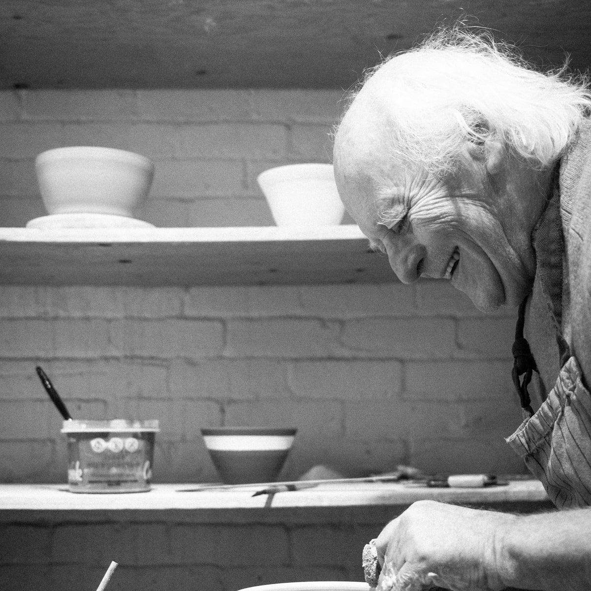 Jacques Benoit making a pot on his pottery wheel.