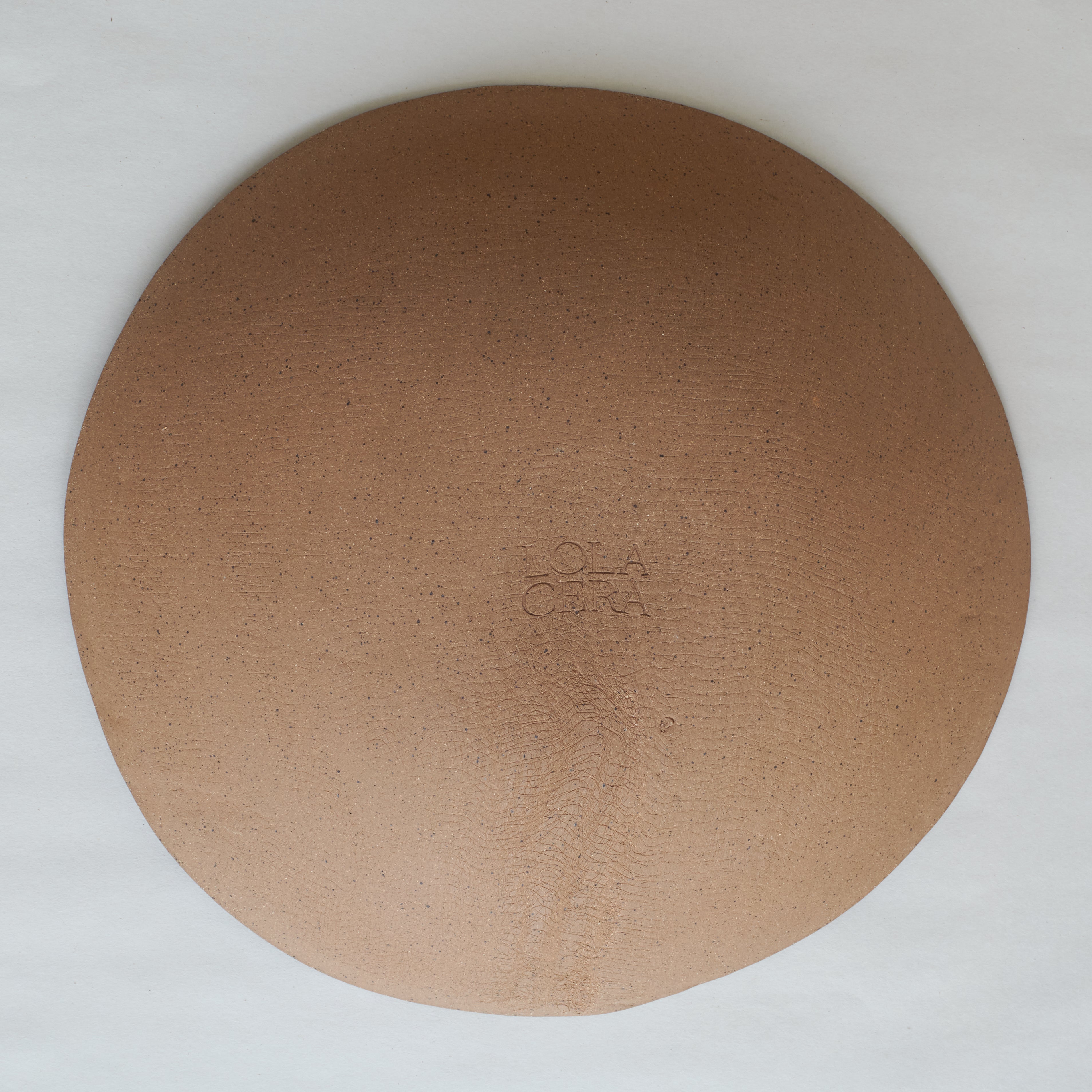 Round brown ceramic with 'LOLA CERRA' branding on a white background.