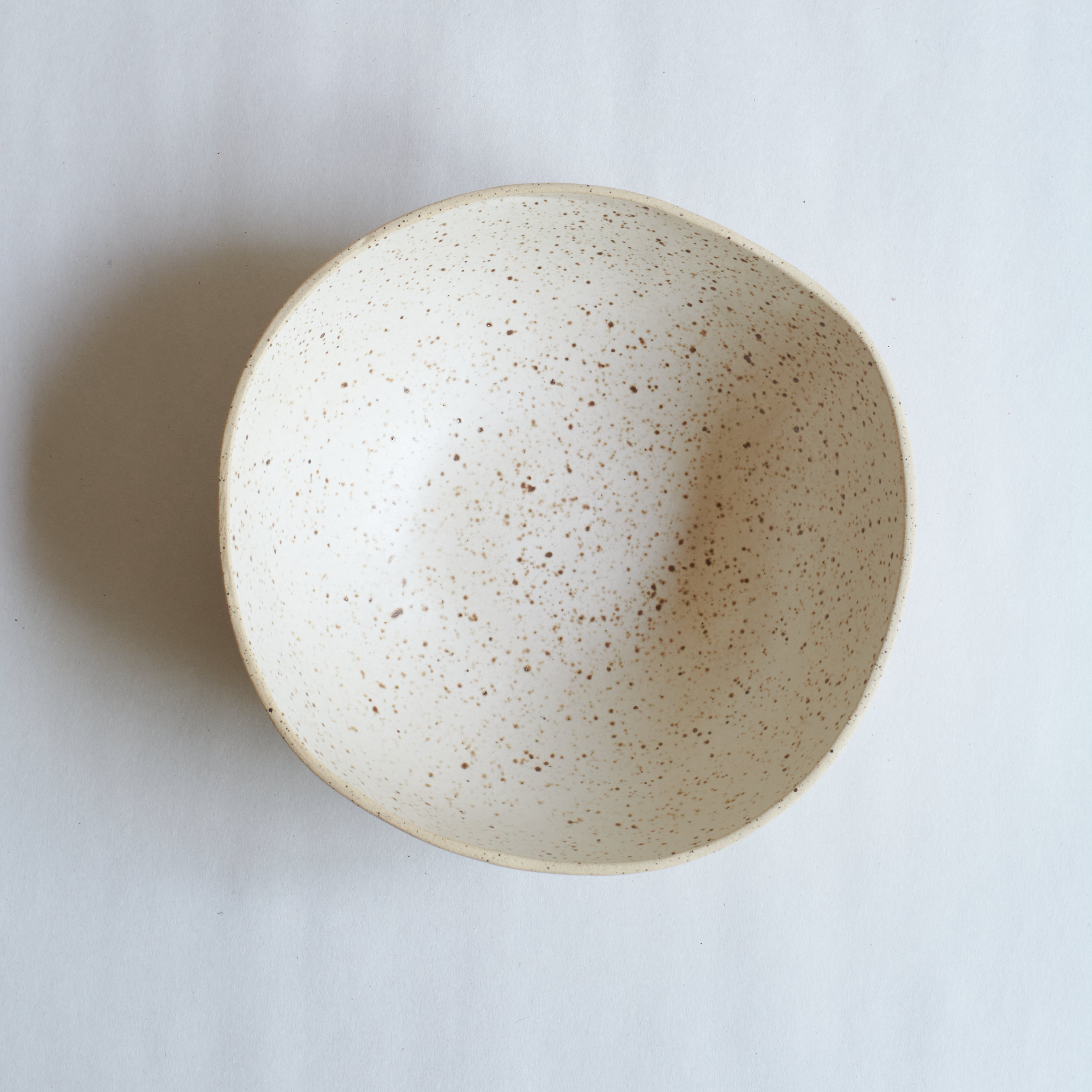 Large off-white bowl made of speckled stoneware