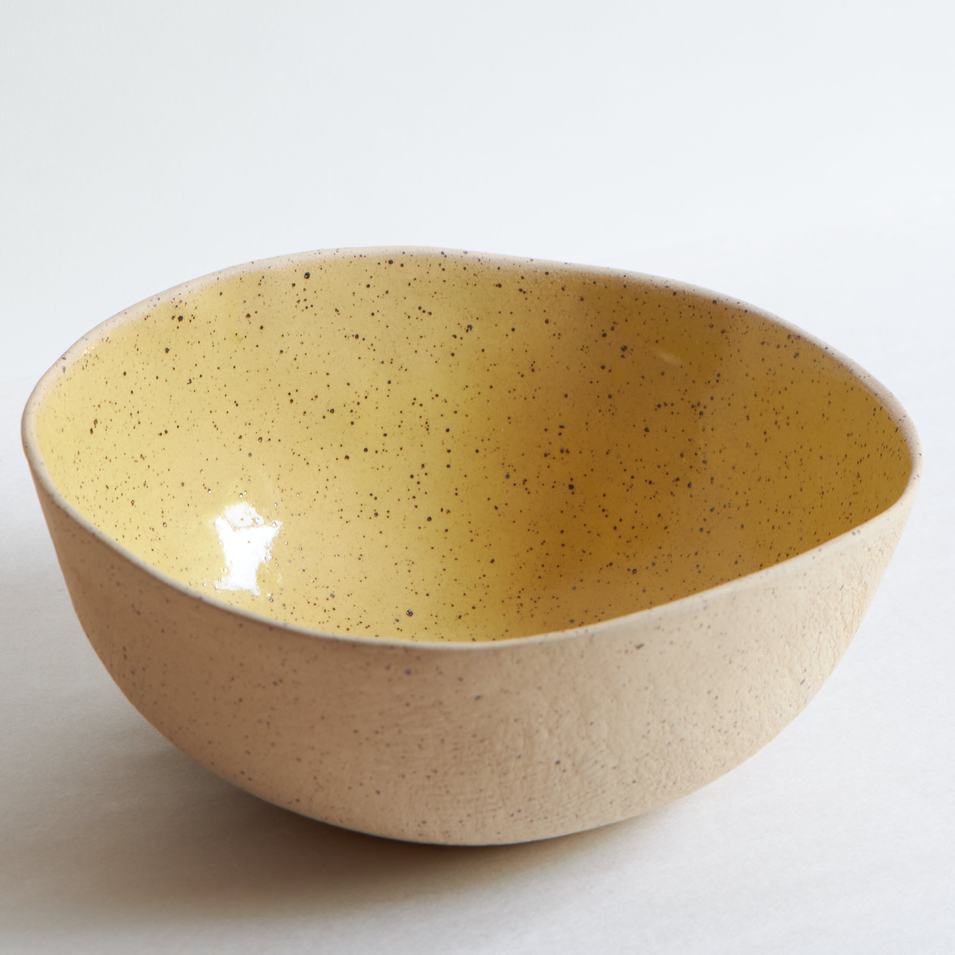 Large yellow bowl made of speckled stoneware