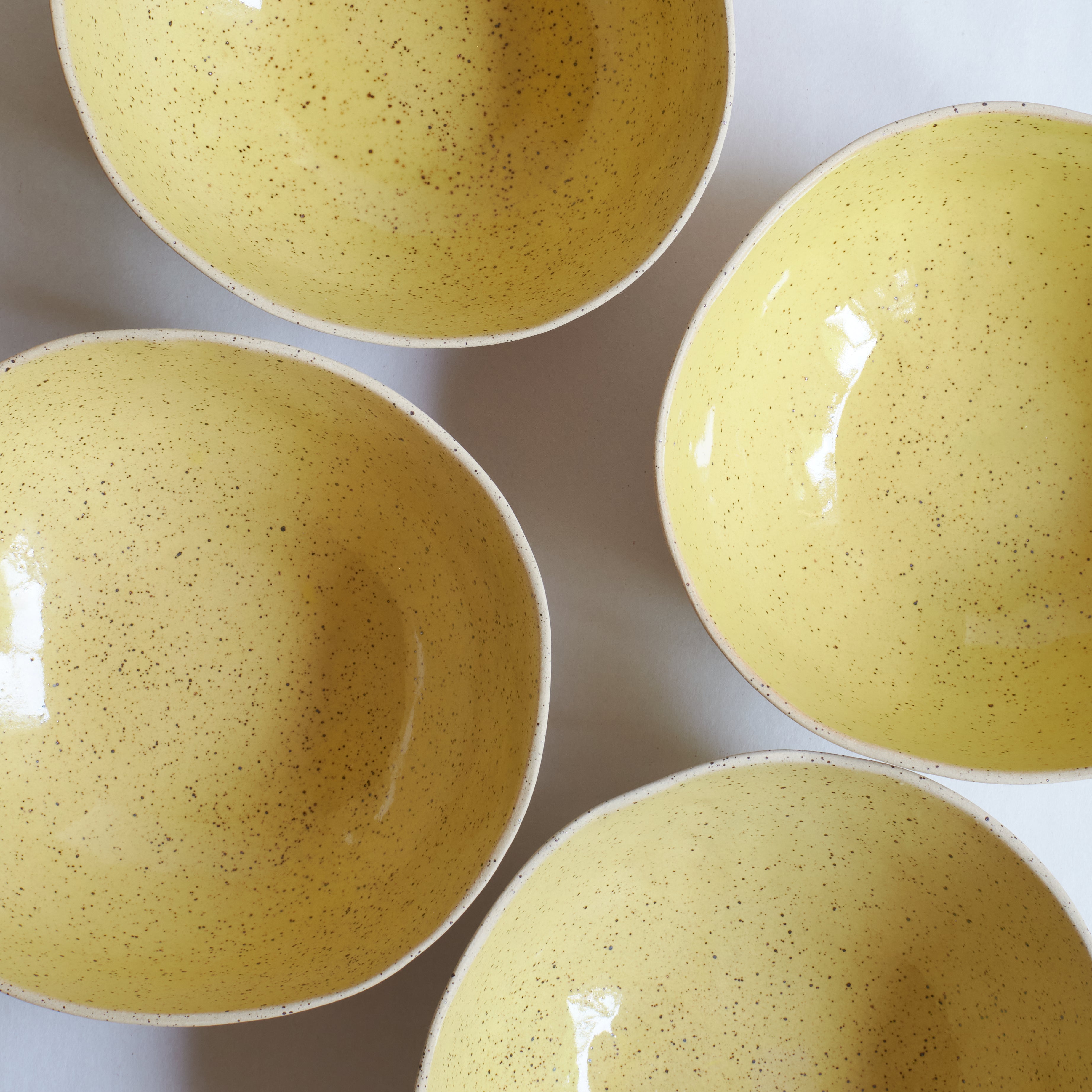 Large yellow bowls made of speckled stoneware