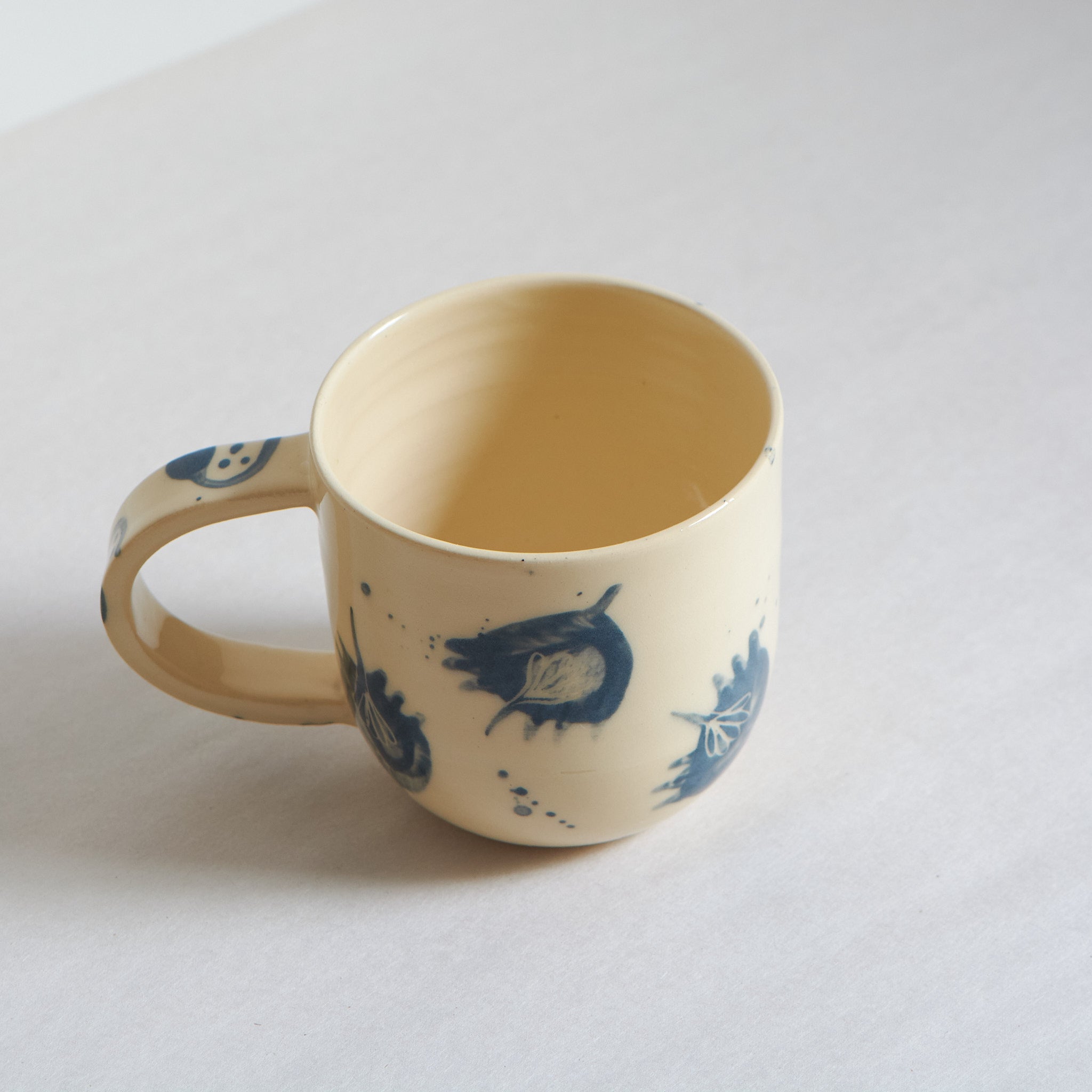 Small blue and white earthenware cup with unique carvings