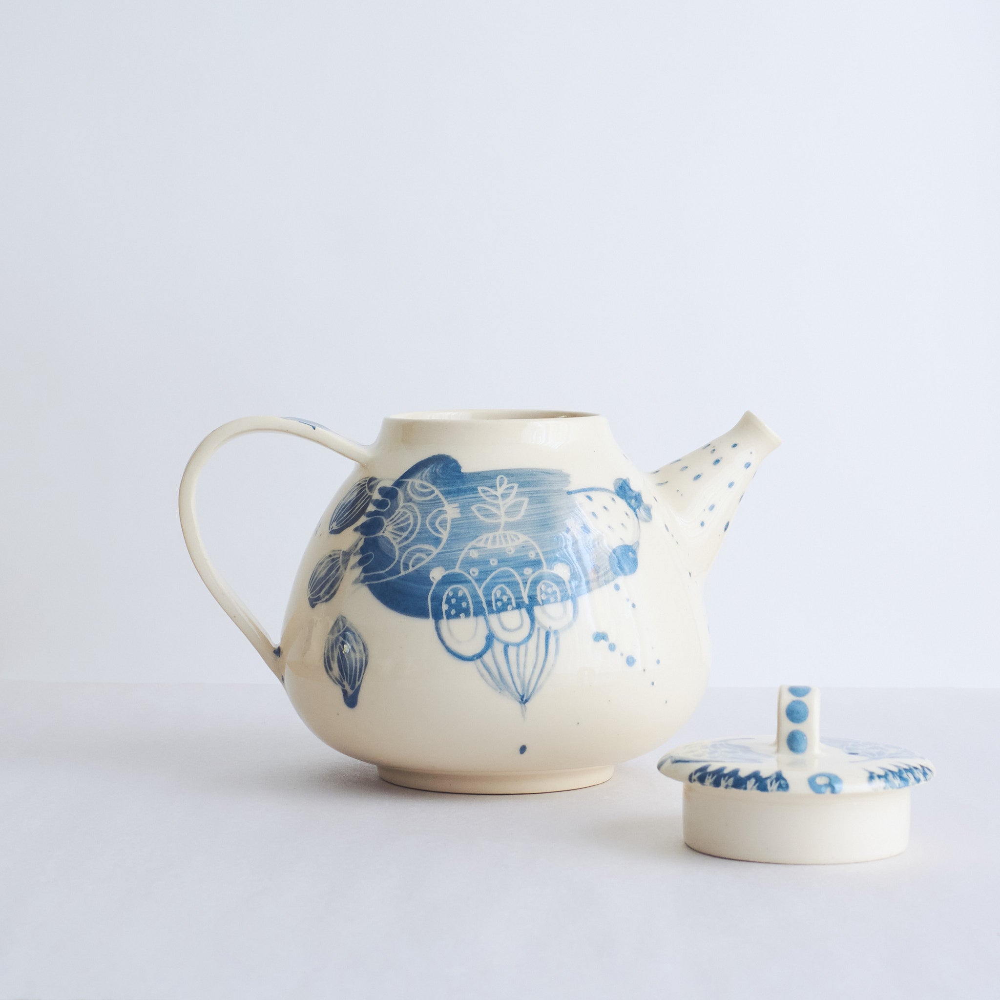 White earthenware teapot with blue carvings