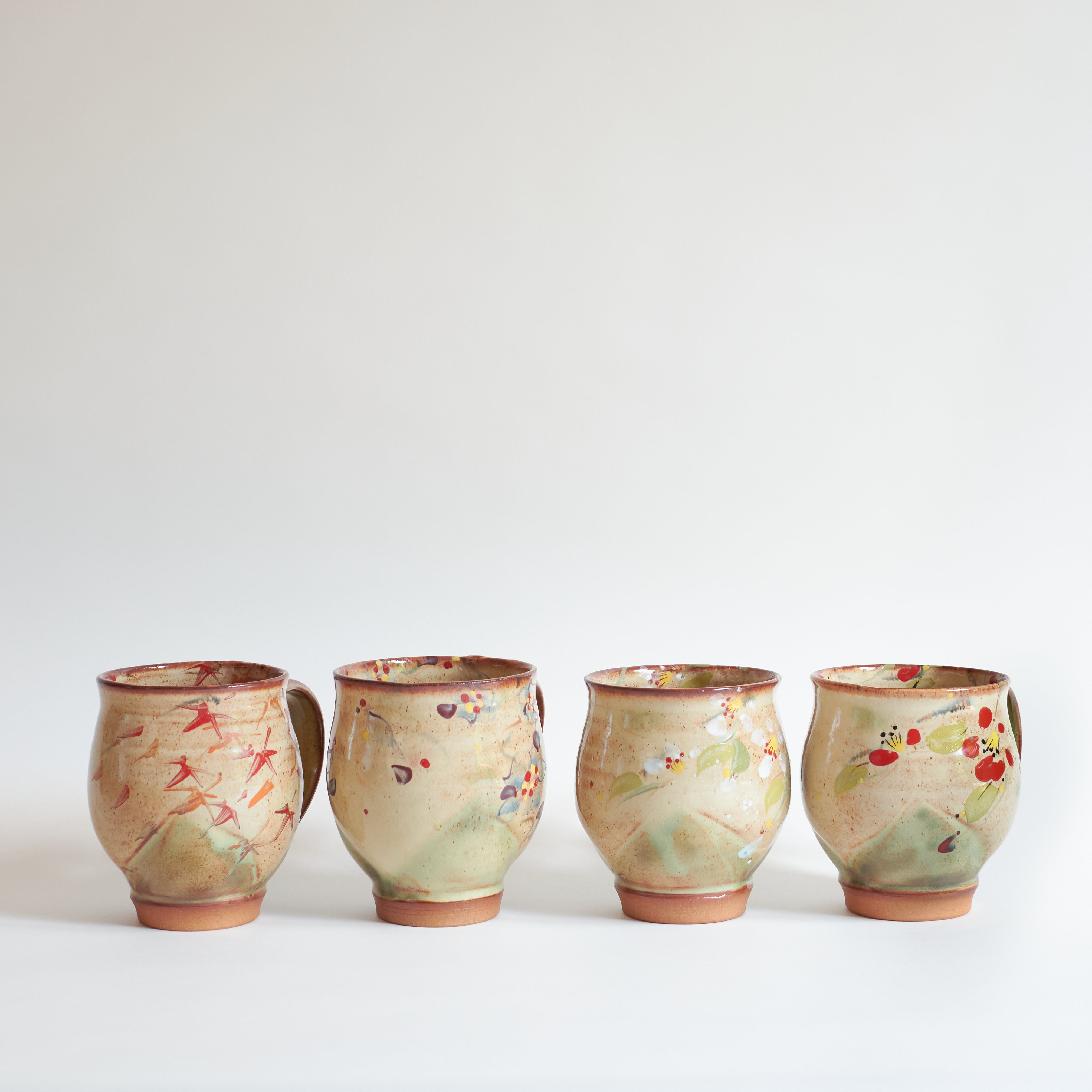 Four ceramic cups with floral patterns