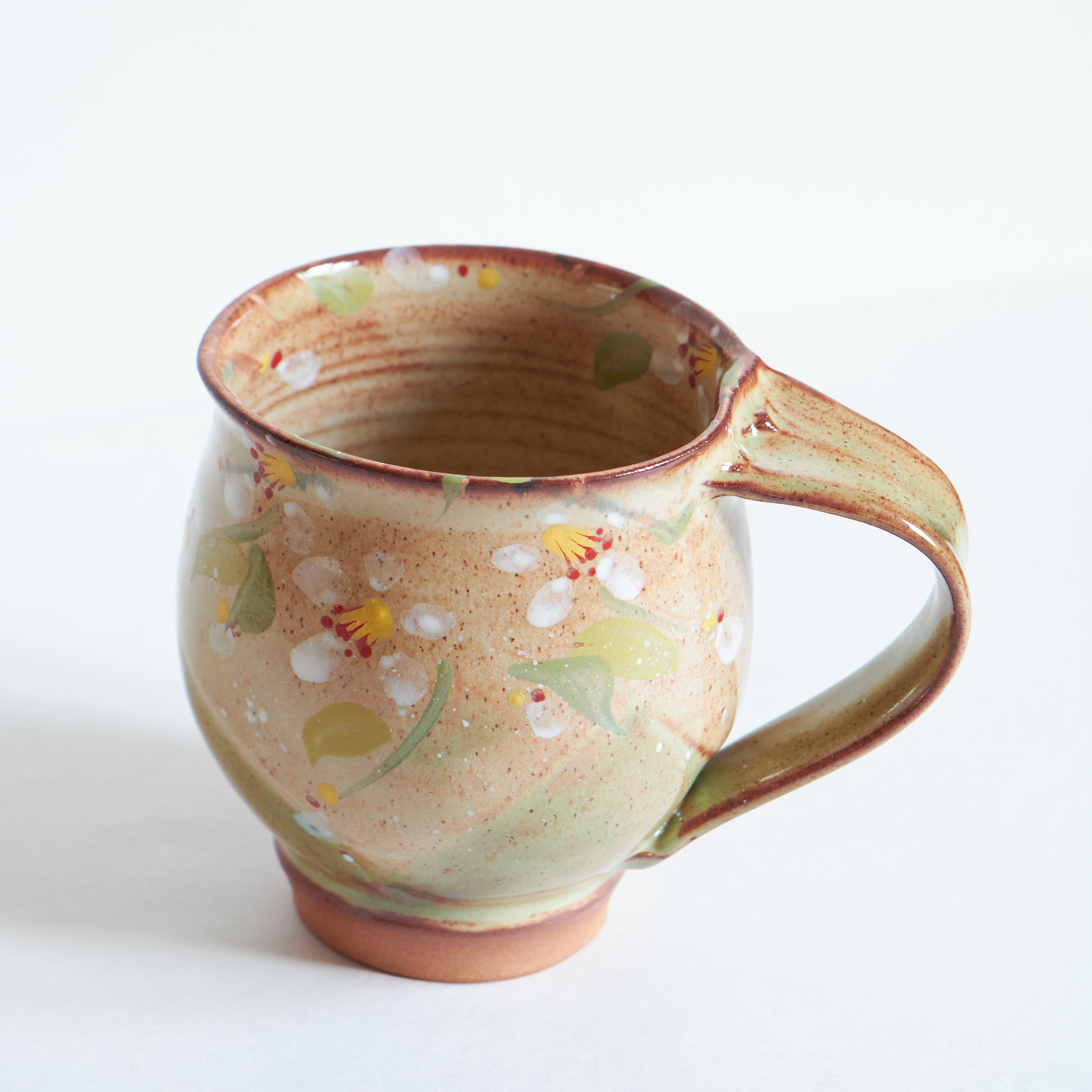 Handmade ceramic mug with Japanese cherry blossom patterns.
