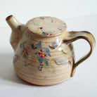 Ceramic teapot with morning glories on a white background