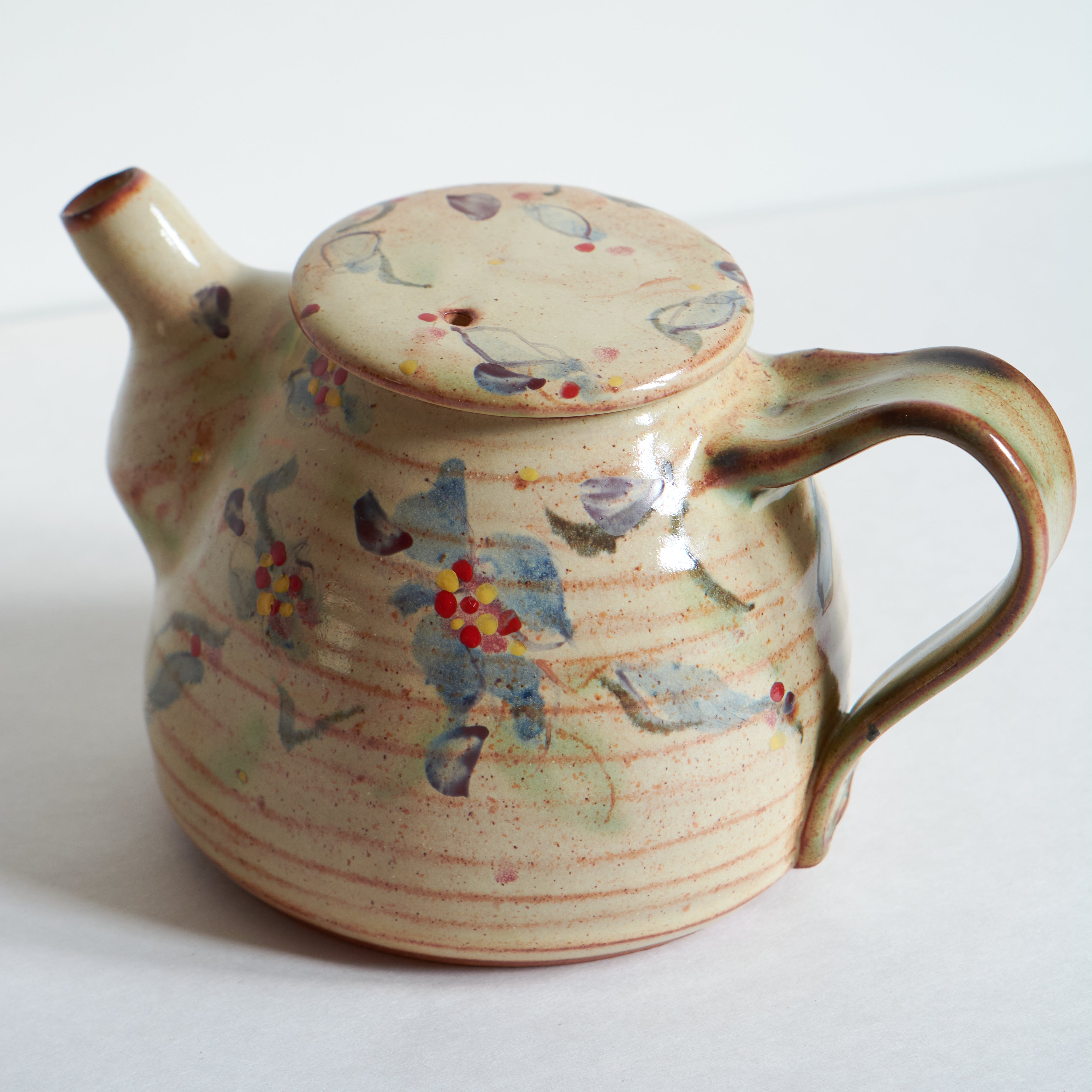 Ceramic teapot with morning glories on a white background