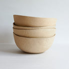 Stack of large bowls made of speckled stoneware 