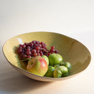 Yellow fruit bowl made of speckled stoneware