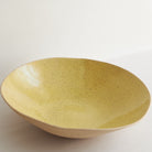 Yellow fruit bowl made of speckled stoneware