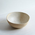 Large off-white bowl made of speckled stoneware 