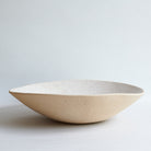 Off-white ceramic bowl on a light gray background