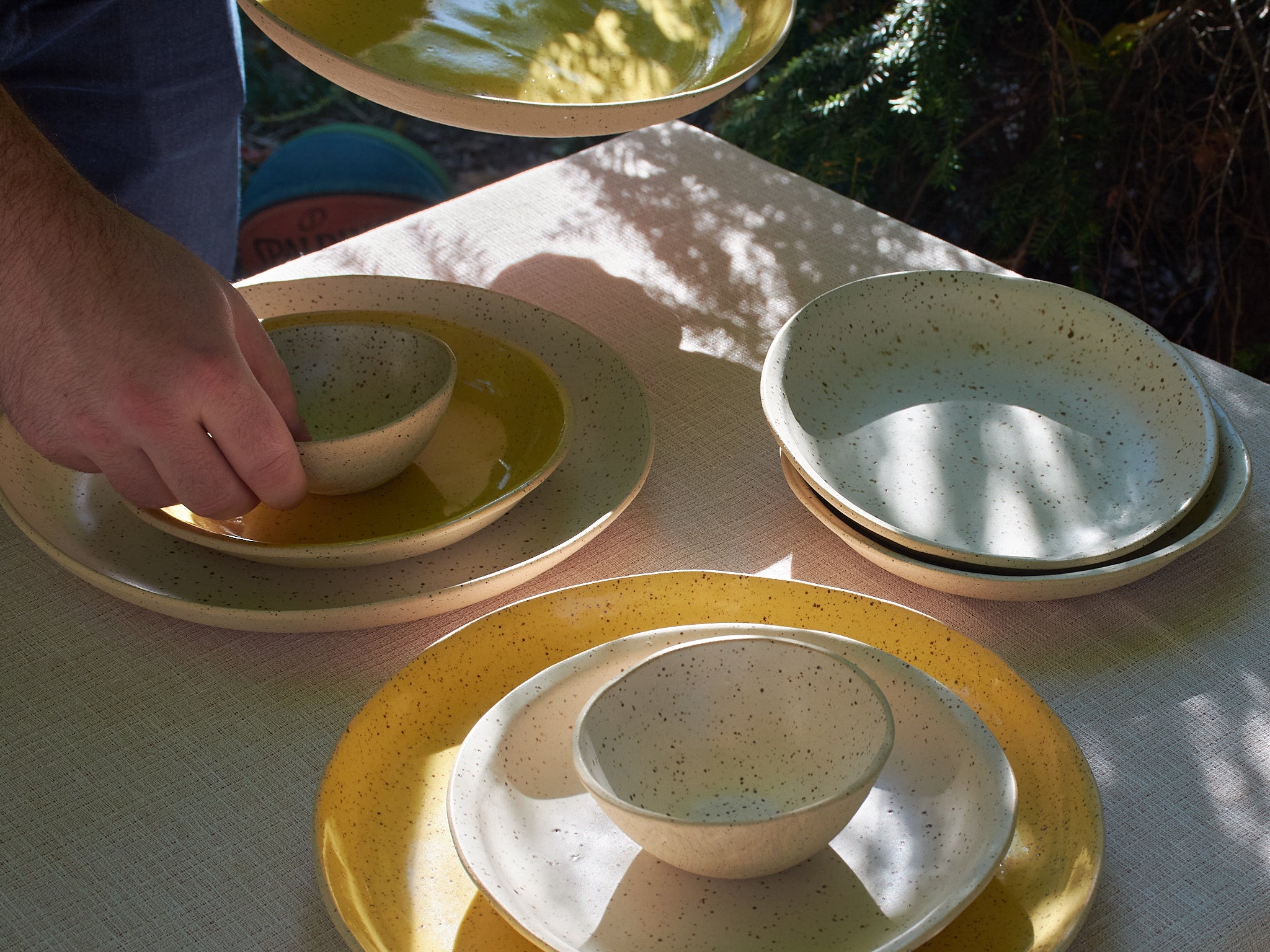 Lola Cera ceramic plates and bowls on a table outdoors