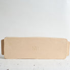 Underneath view of  yellow rectangular serving platter made of speckled stoneware