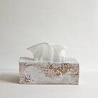Ceramic tissue box cover with white tissues on a light gray background
