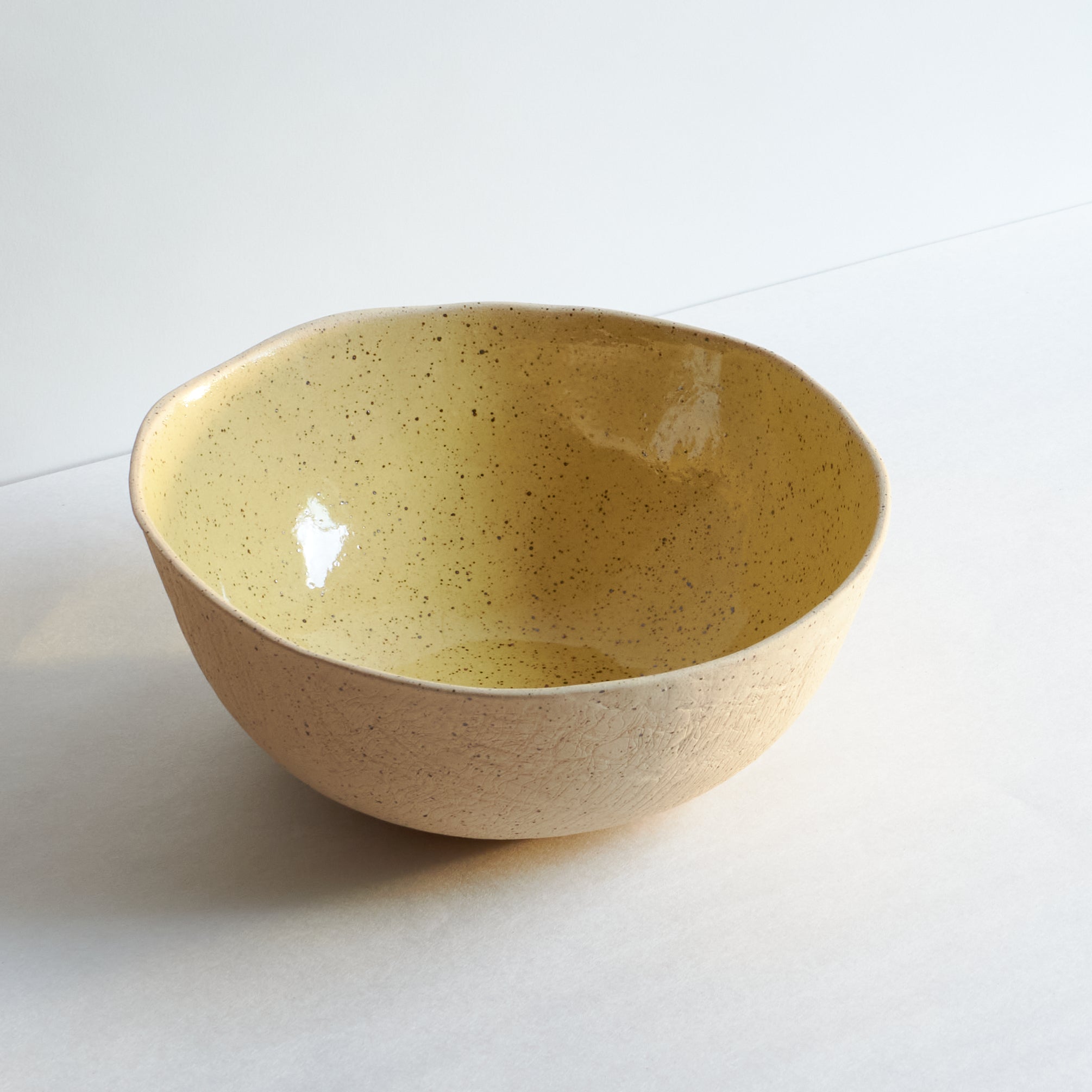 Large yellow bowl made of speckled stoneware 