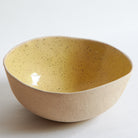 Large yellow bowl made of speckled stoneware 