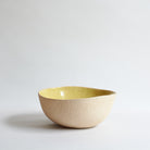 Large yellow bowl made of speckled stoneware 