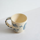 Small blue and white earthenware cup with unique carvings