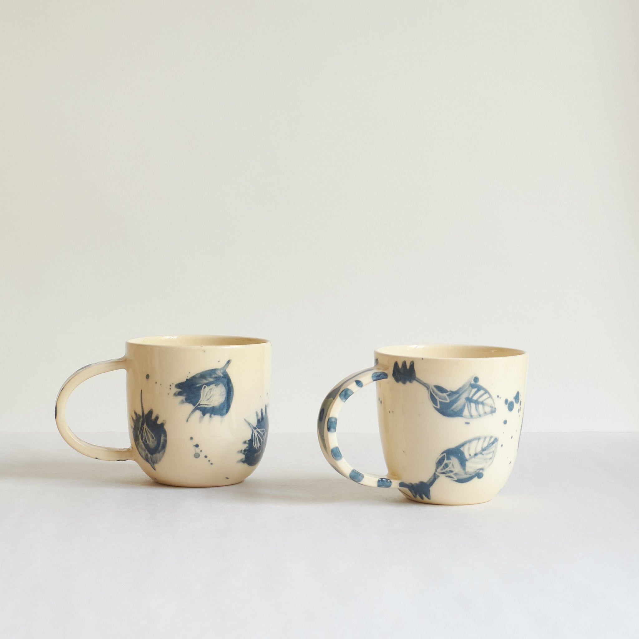Small blue and white earthenware cups with unique carvings