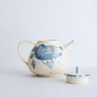 White earthenware teapot with blue carvings