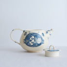 White earthenware teapot with blue carvings