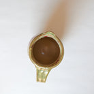 Inside of ceramic pitcher with winter camellia design on a white background