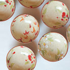 Set of ceramic sake bowls with floral patterns on a white background