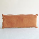 Back of rectangular ceramic dish with red clay on a light gray background