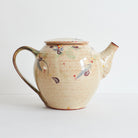 Side view of ceramic teapot with morning glories design on a light background