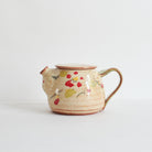 Ceramic teapot with winter red camellia design on a white background